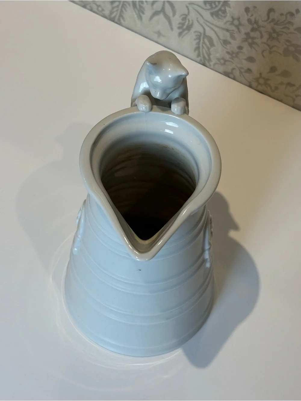 Vintage White Porcelain pitcher with a cat as a handle. Holds 20oz.